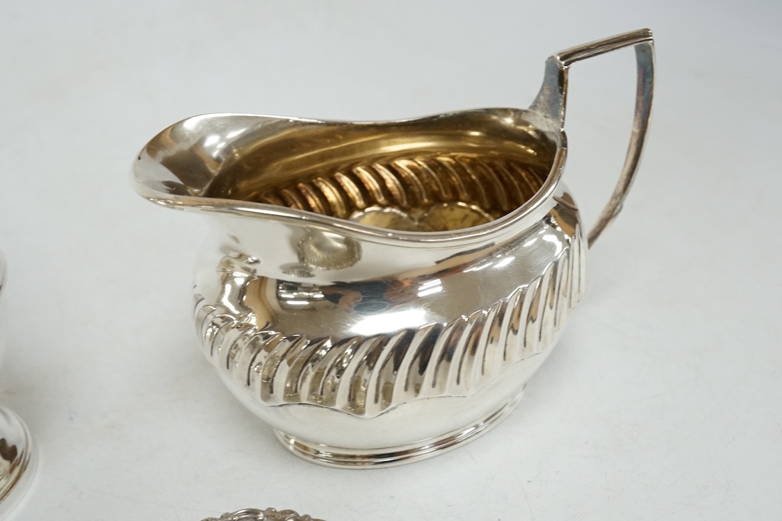 A 1970's silver sugar castor by SCR Ltd, London, 1973, 14.7cm, together with a small silver milk jug and a pair of late Victorian small silver dishes, Miller Brothers, Birmingham, 1899.